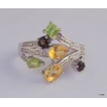 A 9ct white gold diamond shoulder and mixed stone ring size O