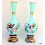 A pair of Vaseline glass hand painted vases 29cm tall and 10cm in the middle