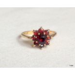 A 9ct gold garnet ring size L