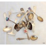 A mixture of silver spoons and child's feeding spoon set