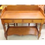 A mahogany two drawer writing table on turned leg supports with an under tray 71 x 106 x 47