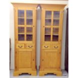 A pair of German built solid pine glazed display units consisting of a 3 shelved glazed display