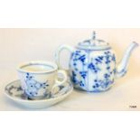 A miniature continental teapot and saucer