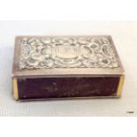 A silver hallmarked matchbox holder with a scrolling beadwork and garland motif London 1896
