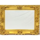 A swept gold framed mirror, 90 x 120cm
