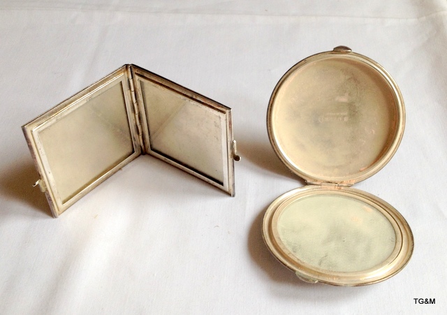 A silver picture frame with a silver compact