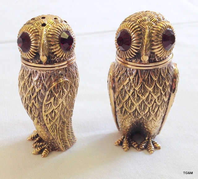 A pair of owl condiments with glass eyes stamped 800 to the base