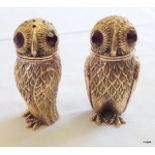 A pair of owl condiments with glass eyes stamped 800 to the base