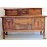 An Arts & Crafts oak sideboard with carved panels and brass fittings 129 x 184 x 60cm