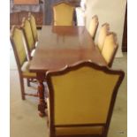 A heavy rectangular refectory dining table with 8 chairs to include 2 carvers 76 x 200 x 90