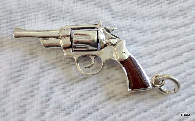 A silver revolver with wooden handle