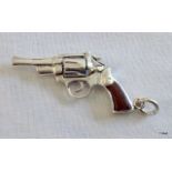 A silver revolver with wooden handle