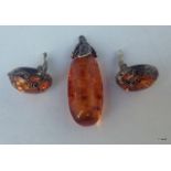 An amber and silver set earrings and pendant