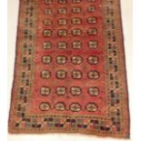 A Blooch quality rug in rusty red colour with a repeated design 267 x 128cm