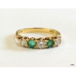 An 18ct gold emerald and diamond ring approx 0.6ct diamond 0.4ct emerald size P