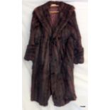 A ladies dark fur coat full length