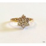 An 18ct gold and diamond daisy ring approx 0.6ct size M/N
