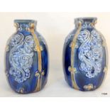 A pair of monogrammed Doulton Lambeth stoneware vases each of ovoid form with a square neck,