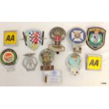 A collection of vintage car grill badges and emblems