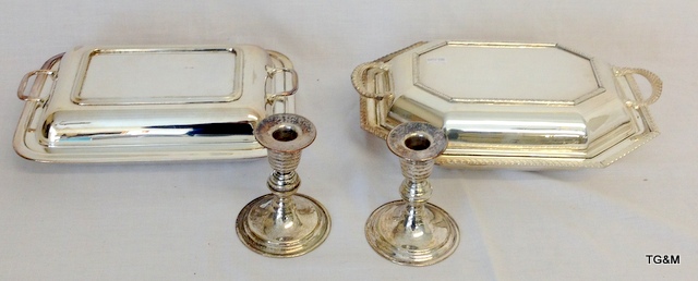 2 silver plated lidded serving dishes and a pair of plated candlesticks (candlesticks 11cm high)