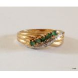 A 9ct gold Emerald and diamond crossover ring hallmarked size M