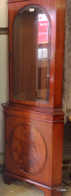 A flame mahogany glass fronted corner unit