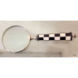 A large hand held magnifying glass