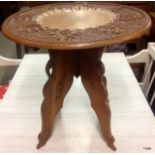 A carved wood oriental table