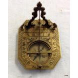 A brass compass and sun dial