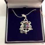 A large silver cz and mystic topaz pendant necklace