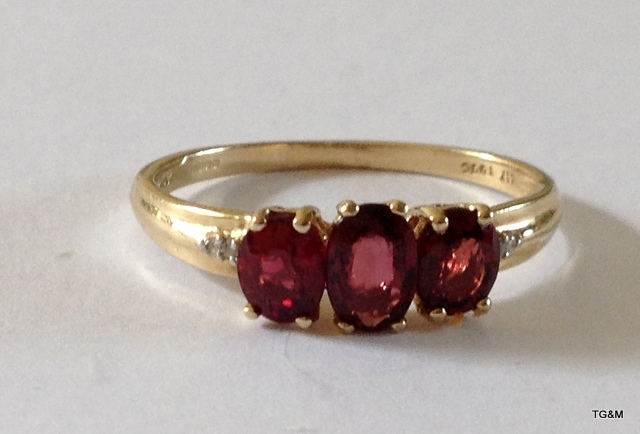 A 9ct gold 3 stone ruby ring size Q