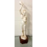 A 19th century carved ivory figure of an African lady on walnut stand