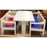 A white painted kitchen table with bench chair and 2 other chairs