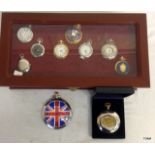 A 3 drawer display case containing a number of pocket watches