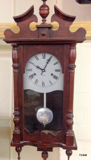 A mahogany wall clock