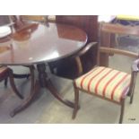 A mahogany extending dining table and chairs