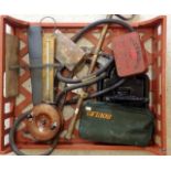 A tray containing various vintage items to include stirrup pump, fishing reel, thermindor picnic