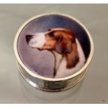 A silver and enamel set pill box depicting a dog