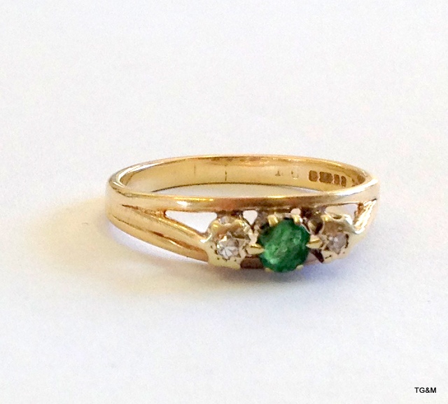 A 9ct gold ladies diamond and emerald ring size O