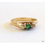 A 9ct gold ladies diamond and emerald ring size O