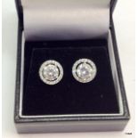 A pair of silver and CZ earrings