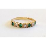 A 9ct gold diamond and emerald 1/2 eternity ring size N
