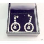 A pair of silver and cz earrings