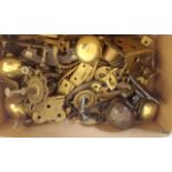 A quantity of brass door knobs, key fobs, handles and other items and fittings