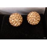 A pair of silver ball shaped ear studs
