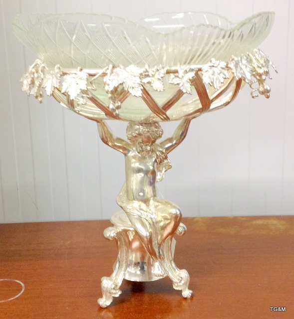 An ornate silver plate and glass centre piece