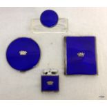 A set of matched items in silver including a cigarette lighter and case, perfume bottle and compact