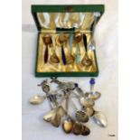 A collection of silver and enamel spoons etc