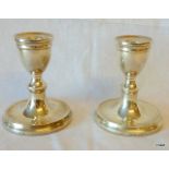 A pair of silver dwarf candlesticks