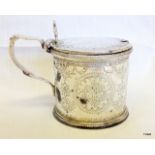 A silver mustard pot with liner